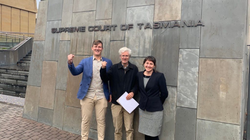 Jack Redpath and Peter McGlone of TCT with EDO Managing Lawyer Claire Bookless standing outside court smiling